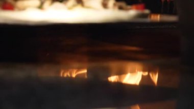 Geleneksel İtalyan pizza fırınına pizza koyarak uzun kürek yakın çekim. Çerçeve. İtalyan pizzacı ve Geleneksel Pizza fırın