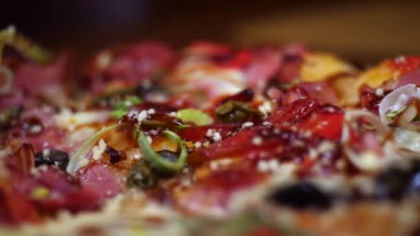 Close-up of fresh tasty Italian pizza with salami, mozzarella cheese, bacon, tomato sauce and pepper. Frame. Traditional Italian Food — Stock Video