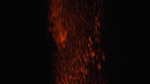 Close-up view of orange powder falling down from the top on the black background. Frame. Bright colors on black — Stock Video