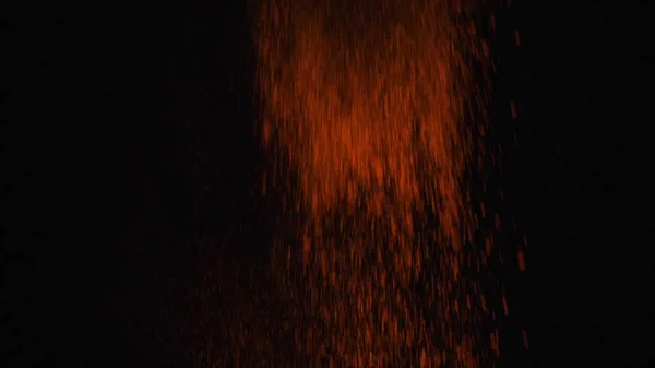 Vista ravvicinata della polvere arancione che cade dall'alto sullo sfondo nero. Cornice. Colori vivaci sul nero — Foto Stock