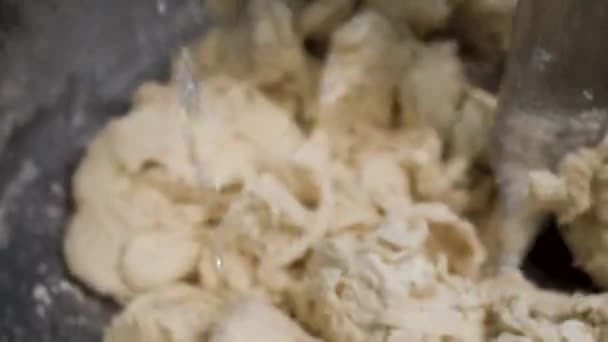 Close up for water being put into the kneating dough at the industrial bakery dough mixer. Stock footage. Automatic equipment for pastry mixing, food preparation concept. — Stock Video