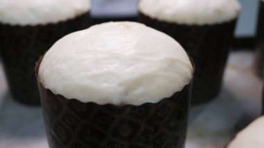 Close-up of Easter cakes with a white caps standing on the table. Stock footage. Traditional Slavic festive homemade bread for the celebration of Orthodox Easter