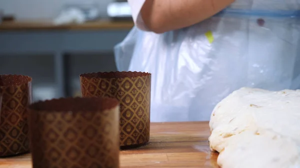 Close-up of female baker's hands in silicone gloves making Easter cakes and preparing dough on the wooden board. Stock footage. Traditional homemade bread for the celebration of Orthodox Easter — Stockfoto