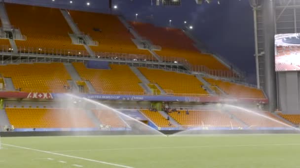 Estádio de futebol com rega de campo antes do campeonato. Acção. Rega dispositivo de pulverização de relva verde esportes grande estádio ao ar livre, preparando-se para o grande campeonato de futebol — Vídeo de Stock