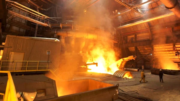 Copper production at the metallurgical plant, dangerous work concept. Stock footage. Molten metal in a huge industrial furnace, heavy metallurgy.