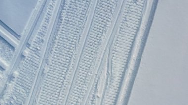 Karda kar motosikletlerinin bıraktığı izler. Görüntü. Kar motosikletçileri tarafından bırakılan beyaz karda açık ayak izlerini en iyi şekilde görebiliyor. Kış taşıma modu