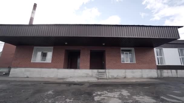 View of exterior of small factory. Action. Facade of old building of small enterprise for processing or production of some materials — Stock Video