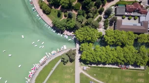 Vue aérienne du canal de la ville avec des bateaux de tourisme, des arbres verts et des maisons par une journée ensoleillée d'été. L'action. Beau paysage de la rivière turquoise avec de petits yachts près du parc de la ville . — Video