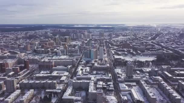 Aerial view of the city and many houses, roads, and yards in the winter time. Clip. Beautiful cityscape with different buildings, urban jungle concept. — Stock Video