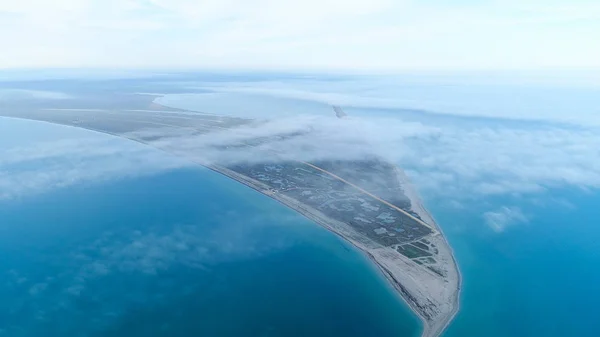 Bovenaanzicht van de kust tussen zee op achtergrond van Sky horizon. Shot. Het hoogste uitzicht in de hemel tussen wolken op de blauwe zee en de driehoekige oever — Stockfoto