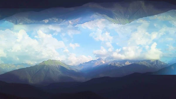 Panorama of mountains with mirror image effect. Shot. Beautiful top view of green valleys of mountains on background blue cloudy sky with mirror effect of inverted world