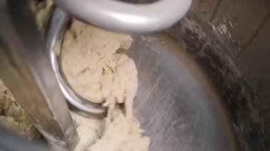 Profesyonel mikserde yoğurma hamurunun yakın çekim. Stok görüntüleri. Hamur fırın veya ekmek fabrikasında endüstriyel yoğurma makinesikarıştırılır
