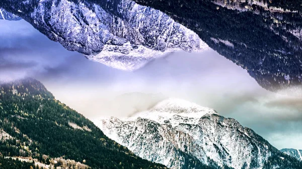 거울 효과와 두 눈 덮인 산의 추상적 인 공중 풍경. 애니메이션. 초현실적 인 거꾸로 거울 세계, 구름에 겨울 숲 바위, 시작 테마. — 스톡 사진