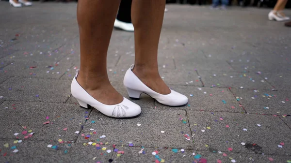 Close up para pernas de homens e mulheres em sapatos brancos dançando na rua durante o feriado nacional. Arte. Alfândegas e tradições espanholas, celebração de carnaval com pessoas de esgrima . — Fotografia de Stock