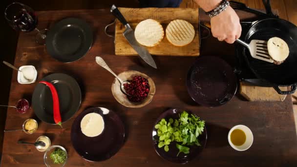 Cozinhe adicionando alface no hambúrguer. Imagens de stock. A preparar hambúrguer. Cozinhe as mãos preparando e fazendo hambúrguer — Vídeo de Stock