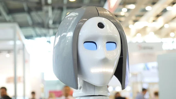 Womans face on a high-tech robot. Media. High-tech robot at the exhibition. Robotic of a human like droid robot