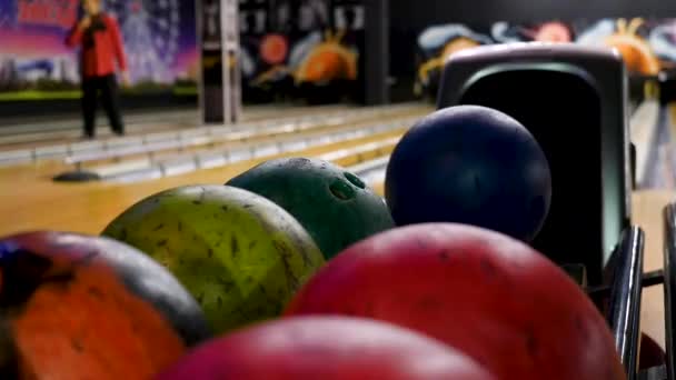 Bola de Bowling fora de Ball Return. Mídia. Bola foi rolada para fora, bolas de boliche varicolored mentira no clube de boliche — Vídeo de Stock