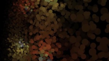 Siyah arka planda parıldayan çok renkli parçacıklar beliriyor, kayar ve soluyor. Animasyon. Güzel parlak parçacıkların keyifli soyut animasyon