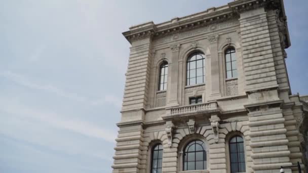 Stone architectural building on sky background. Action. Beautiful old building of white stone in style of european architecture — Stock Video