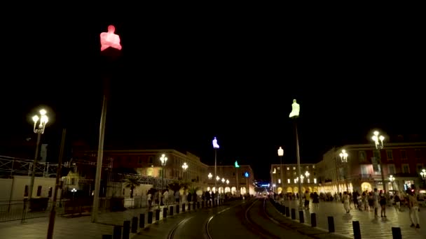 Night town square with walking tourists. Action. Beautiful lights illuminating city alley with walking tourists in summer night. City square with european style houses is filled with people — Stock Video