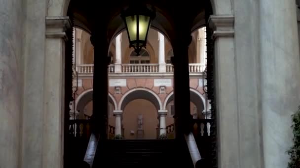 Arched passage to old architectural building. Action. Arched passages among open halls of old building with columns — Stock Video
