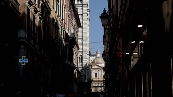 Partie de la cathédrale sur fond de maisons. L'action. Tour de la cathédrale est visible depuis la rue étroite parmi les bâtiments résidentiels sur fond de ciel bleu — Photo