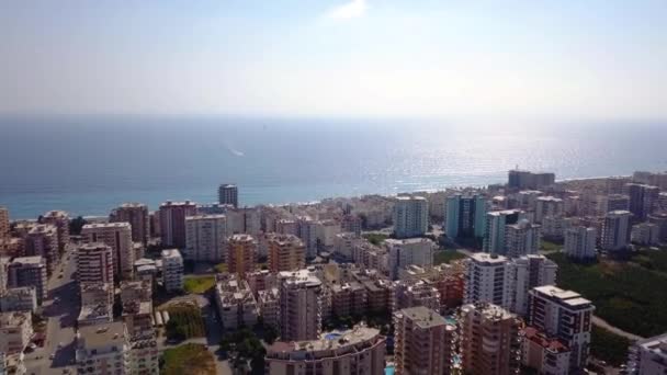 Vista superior de la ciudad turística en el fondo del mar y el horizonte con el cielo. Clip. Panorama de la costa del complejo en el fondo del horizonte del mar con cielo soleado — Vídeos de Stock