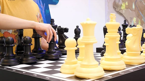 Close up for people playing giant chess, board games concept. Media. Two classmates play big chess at a science activity centre. — Stock Photo, Image