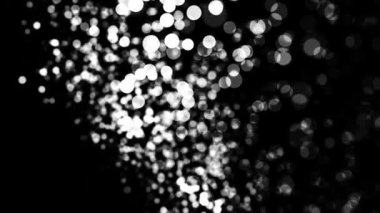 Siyah arka planda uçan parlak beyaz bokeh ışıkları, monokrom. Animasyon. Kaotik hareketlerde parlayan güzel küçük noktalar, kusursuz döngü.