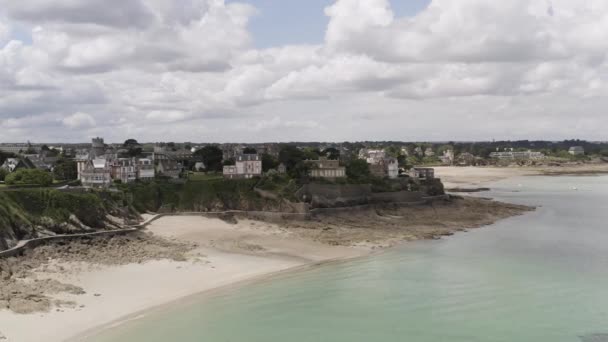 Aerial for the emerald coast located in the Dinard city, Brittany, France. Action. Breathtaking landscape with sea shore and cute cottages on blue cloudy sky background. — Stock Video