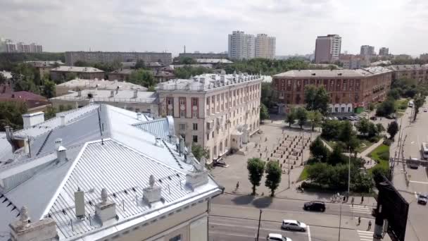 Top view of old buildings and small square in city. Stock footage. Old town with architectural buildings and small square in center on background of cloudy sky — Stock Video