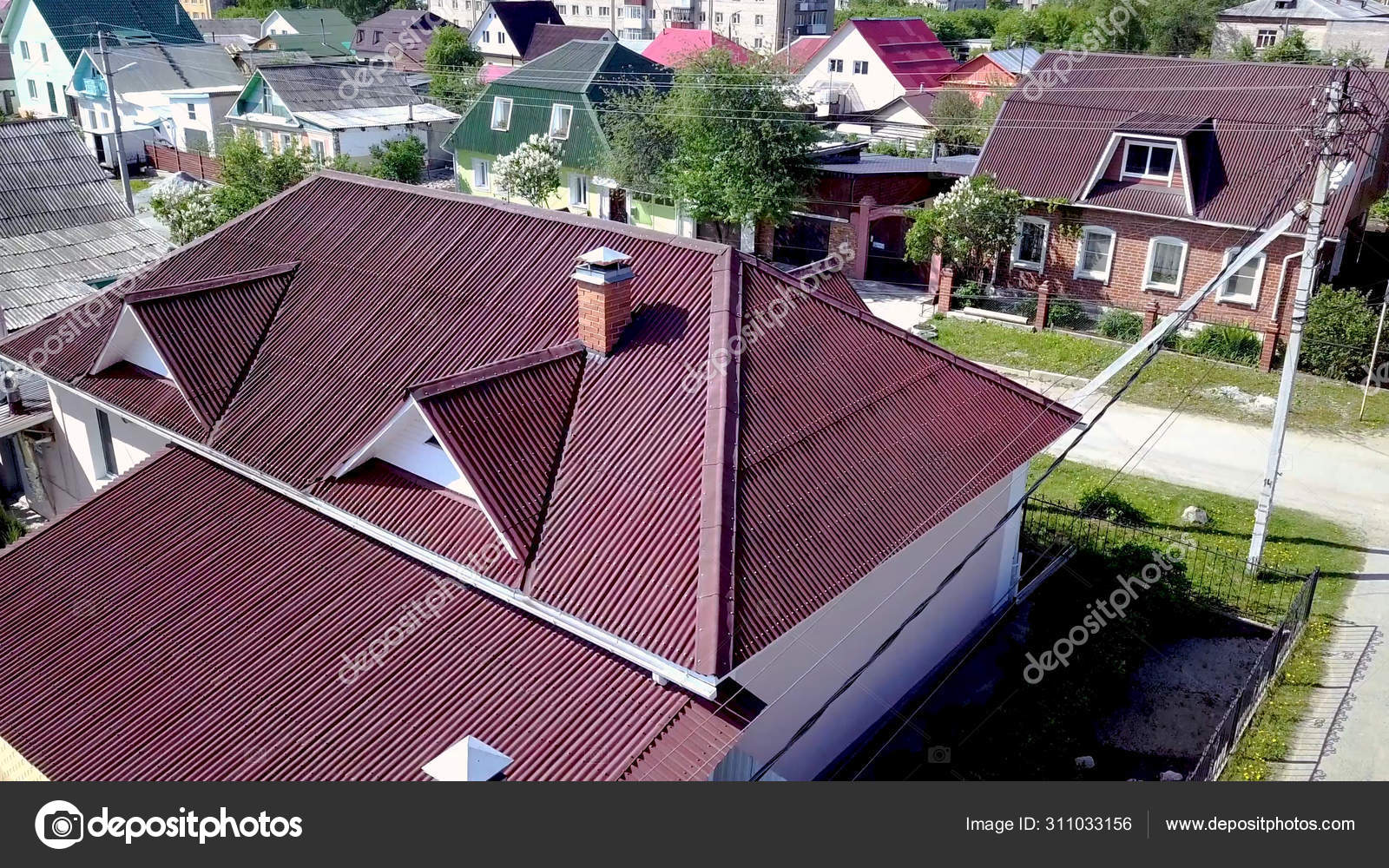 Top view roof of house. Stock footage. Beautiful new roof of house located in village. Roof or dark red looks expensive beautiful Stock Photo by ©MediaWhalestock 311033156