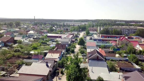 Top kilátás egyenes út a faluban házak. Készletfelvétel. Régi ipari város magánházakkal az erdő és a horizont hátterében — Stock Fotó