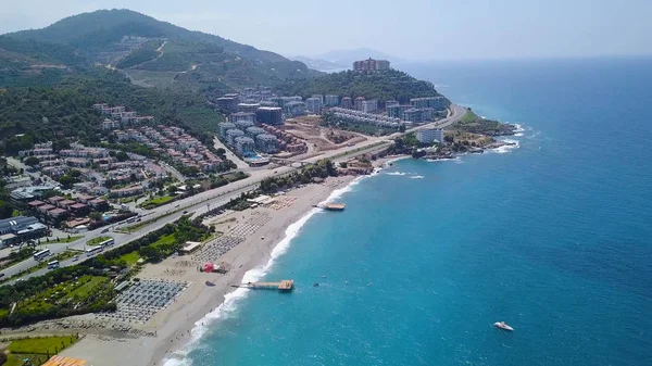 Top view of beach resort town by blue sea. Stock footage. Great place for summer holiday by sea. Modern city with beautiful hotels located on mountain coast — Stock Photo, Image