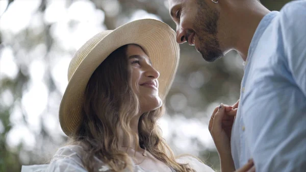 Close-up of newlyweds smiling and caressing. Action. Lovely young couple in love glow with happiness together. Newlyweds smile at each other on their honeymoon — Stock Photo, Image