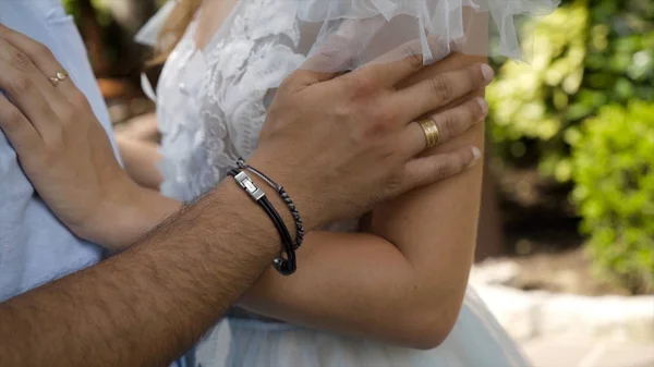 Close-up caressing hands of newlyweds. Action. Gentle touch of hands of loving couple of newlyweds. Beautiful and romantic touch of grooms hands caressing bride — Stock Photo, Image