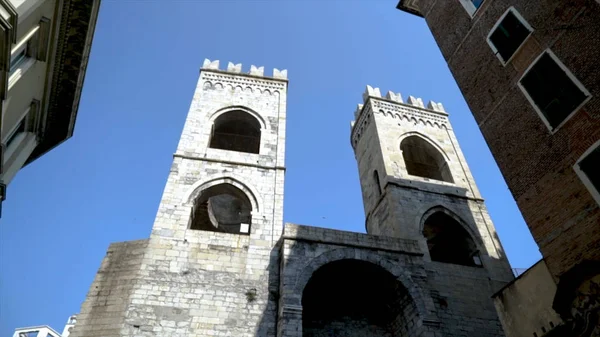 Bottom view of medieval building in old town. Action. Ancient building with stone architecture on blue sky background. Medieval architecture in centre of old town — Stock Photo, Image