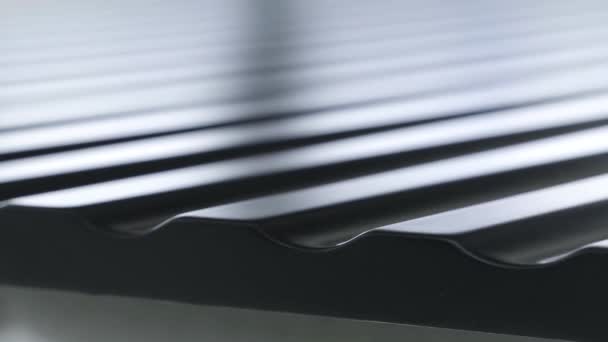 Close up view of black roofing waterproof material, construction and building concept. Action. The edge of the roofing sheet, dark seam shingles. — Stock Footage Close up view of black roofing waterproof material, construction and building concept. Action. The edge of the roofing sheet, dark seam shingles. Royalty Free Stock Footage