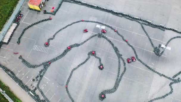 Aerial view of the karts pilots traning or competing on the karting trace in protective uniform and helmet. Media. Kart driving training. Kart racing — Stock Video