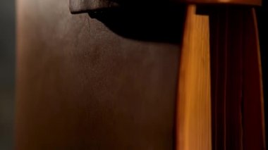 Sarı sayfalı klasik deri kitap. Stok görüntüleri. Kahverengi deri kaplı kadim bir defter ve loş ışığın altında izole edilmiş dikey konumda bir kayış kapat..