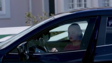 Rich woman gets out of car. Video. Self-sufficient woman bitchily gets out of car and goes to house. Epic exit of bitchy millionairess from car in background of expensive house