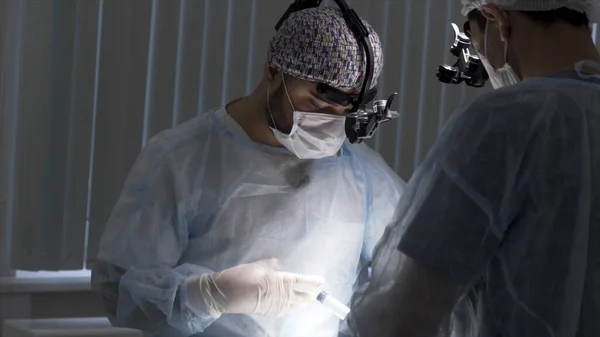 Doctors deliver anesthesia to the surgical patient in the operating room. Action. Close up of doctors performing operation and preparing patient to the procedure. — Stock Photo, Image