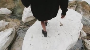 Taşların üzerinde nehri geçen iki yolcu. Şarjör. Genç gezginler taşların üzerinde orman nehrini geçiyorlar. Kayaların üzerinden geçen ilk kişinin vurulması. Ormandaki adamların yaz macerası