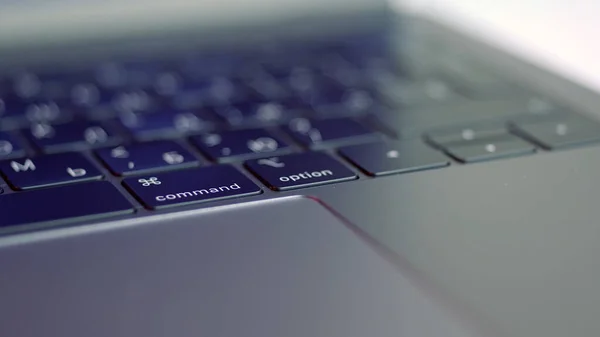 Close up of black keyboard and silver laptop, focus moving slowly. Action. New beautiful technological device, computer with flat buttons and touch pad.