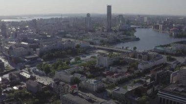 Rusya 'nın Ekaterinburg şehrinin merkezinin havadan görüntüsü. Stok görüntüleri. Bulutlu arka planda bulvarlar, evler ve akan nehirlerle dolu yaz şehri..