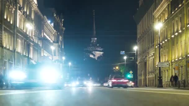 在古建筑和塔楼的背景下，夜晚繁忙的道路。行动。经过繁忙的夜晚街道与古老的建筑。圣彼得堡灯火通明的Nevsky大道 — 图库视频影像