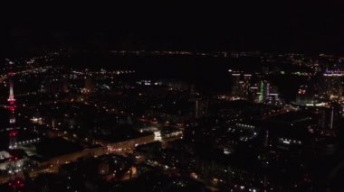 Karanlık gökyüzü arka planında şehir ışıkları olan panoramik manzara. Stok görüntüleri. Uçak penceresinden güzel ışıkları ve gece hayatı konsepti olan büyük bir şehrin manzarası..
