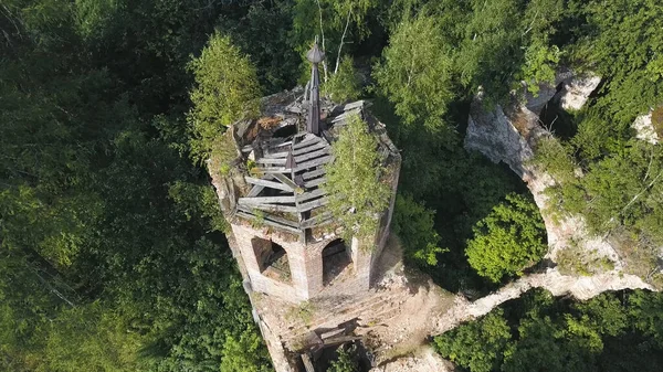 Vista aérea de las ruinas de la iglesia medieval en el bosque verde de primavera. Clip. Concepto de religión, vista superior de las ruinas del monasterio con árboles verdes creciendo a través de. —  Fotos de Stock