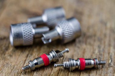 İç lastik valf bir ahşap Atölyesi tablo. İç lastikler ve araba lastik tamiri için icin için aksesuarlar. Koyu arka plan.