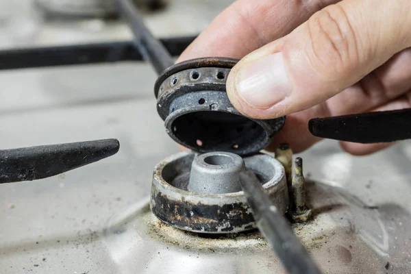 An old dirty gas kitchen. Device for preparing dishes in the kitchen. Dark background.